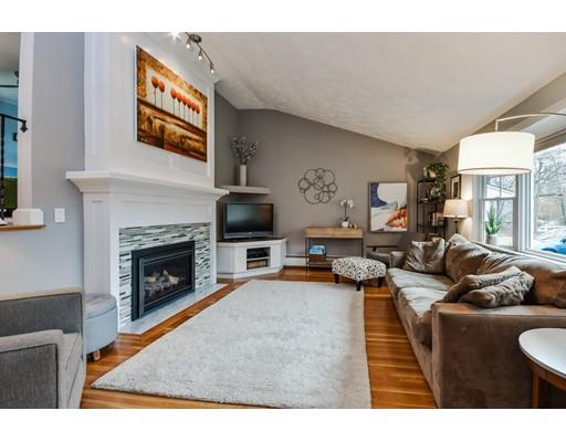 897 Salem End Road Framingham, MA 01702 - Photo 3 of 27 a living room with furniture a flat screen tv and a fireplace