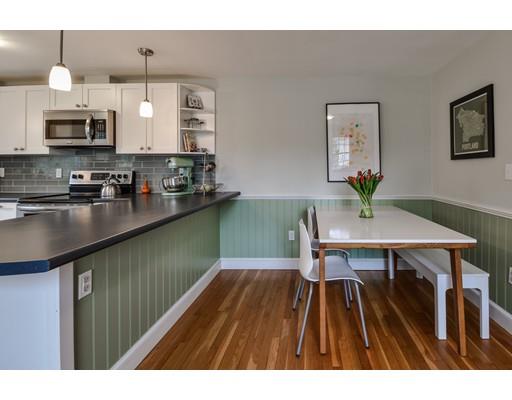 897 Salem End Road Framingham, MA 01702 - Photo 8 of 27 a kitchen with a table chairs refrigerator and microwave