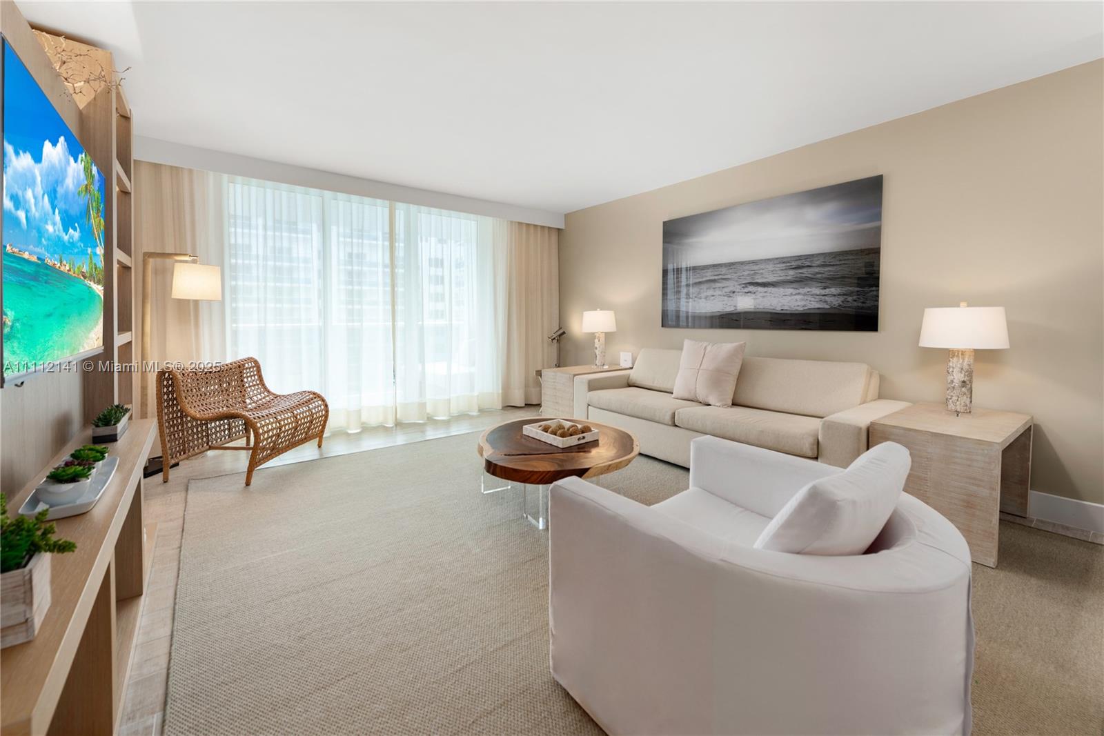 102 24th Street, Unit 1208 Miami Beach, FL 33139 - Photo 17 of 19 a living room with furniture and a flat screen tv