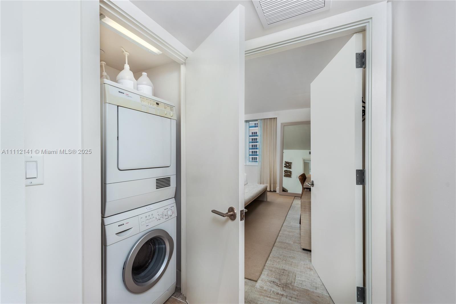 102 24th Street, Unit 1208 Miami Beach, FL 33139 - Photo 6 of 19 a view of a hallway with washer and dryer