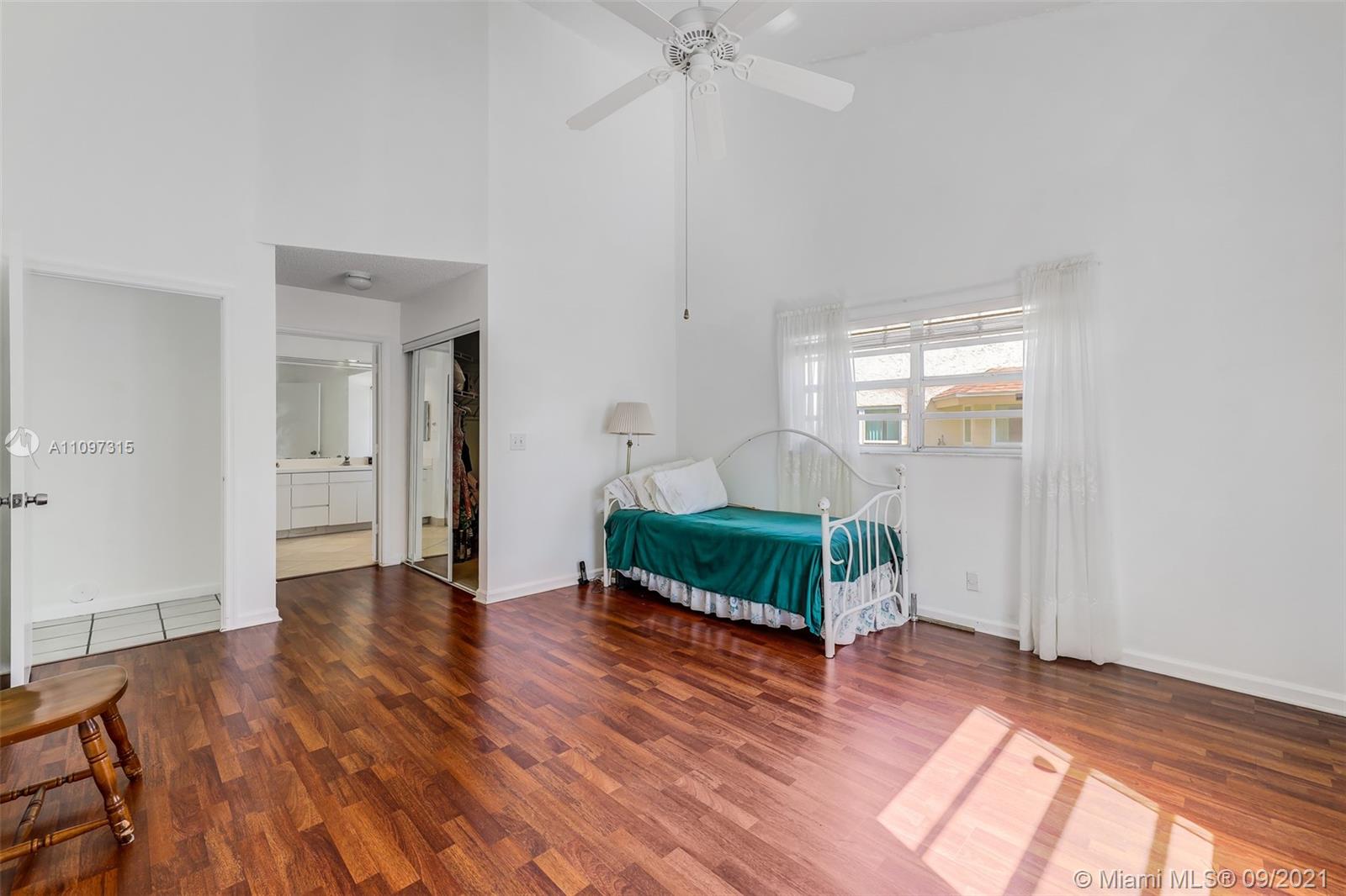 5140 Northwest 5th Avenue Boca Raton, FL 33487 - Photo 20 of 44 an empty room with wooden floor a ceiling fan and windows