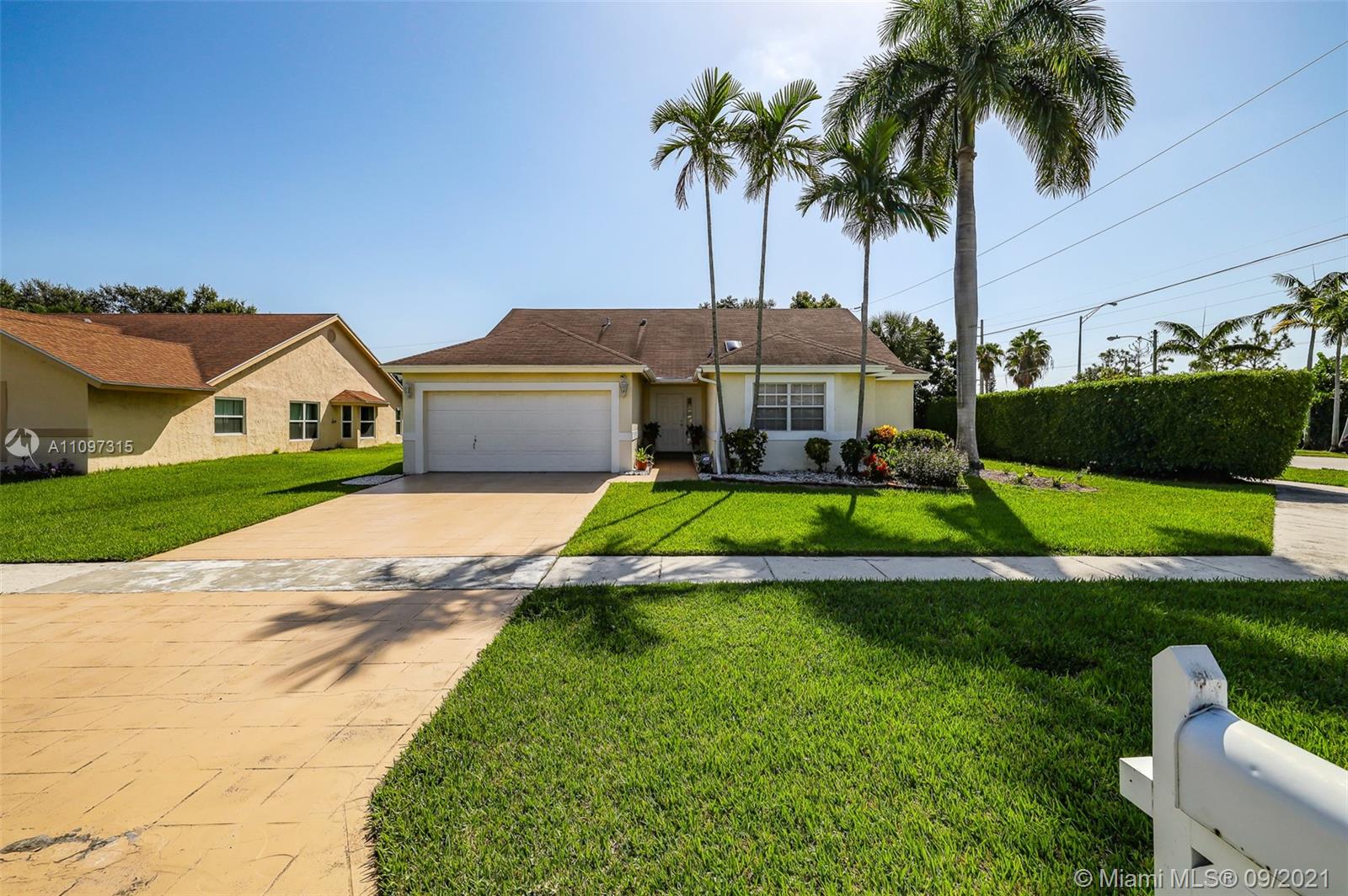 5140 Northwest 5th Avenue Boca Raton, FL 33487 - Photo 3 of 44 a view of a house with a big yard and palm trees