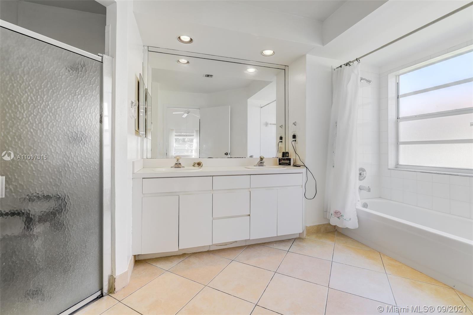 5140 Northwest 5th Avenue Boca Raton, FL 33487 - Photo 23 of 44 a bathroom with a sink a mirror and a bathtub