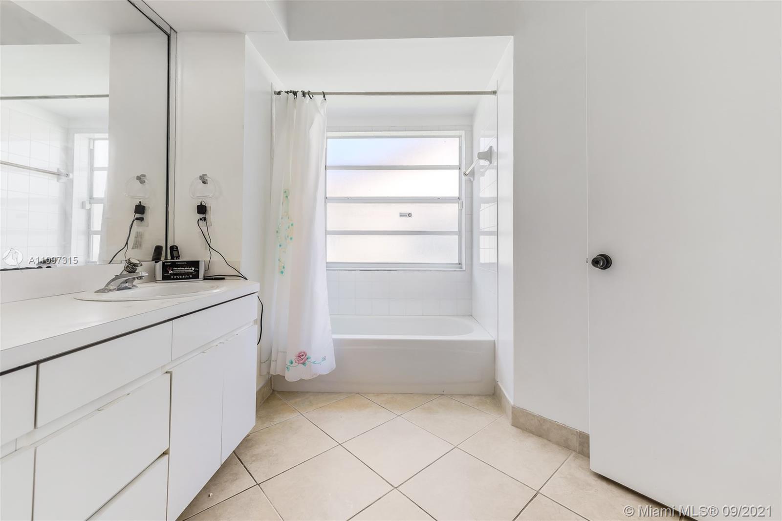 5140 Northwest 5th Avenue Boca Raton, FL 33487 - Photo 24 of 44 a bathroom with a bathtub sink and mirror
