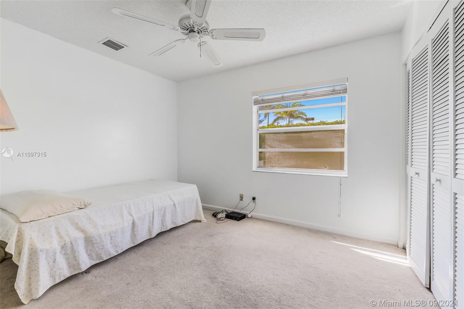 5140 Northwest 5th Avenue Boca Raton, FL 33487 - Photo 26 of 44 a spacious bedroom with a bed and a window