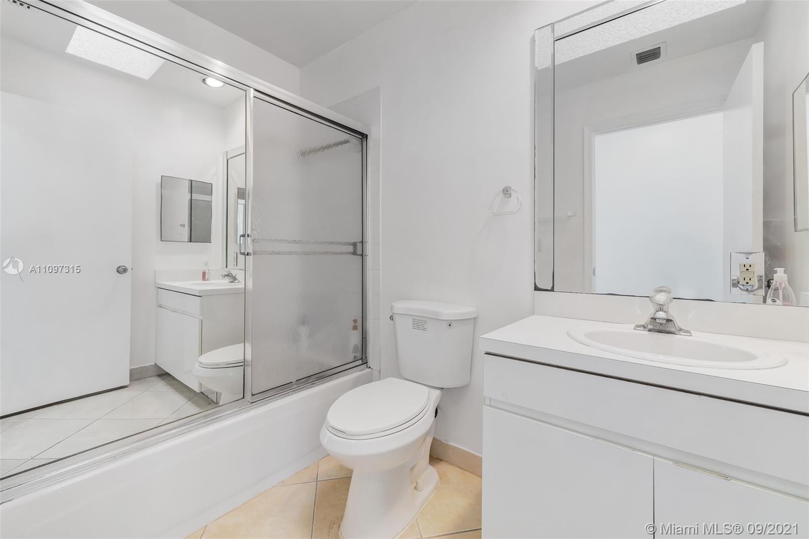 5140 Northwest 5th Avenue Boca Raton, FL 33487 - Photo 30 of 44 a bathroom with a sink a toilet and a mirror
