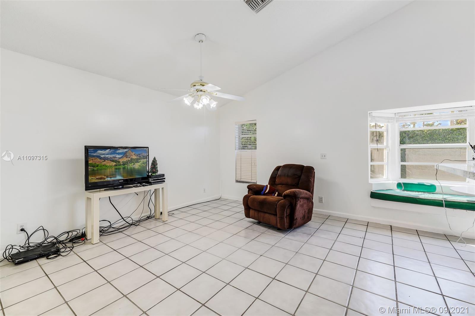 5140 Northwest 5th Avenue Boca Raton, FL 33487 - Photo 34 of 44 a living room with furniture and a flat screen tv