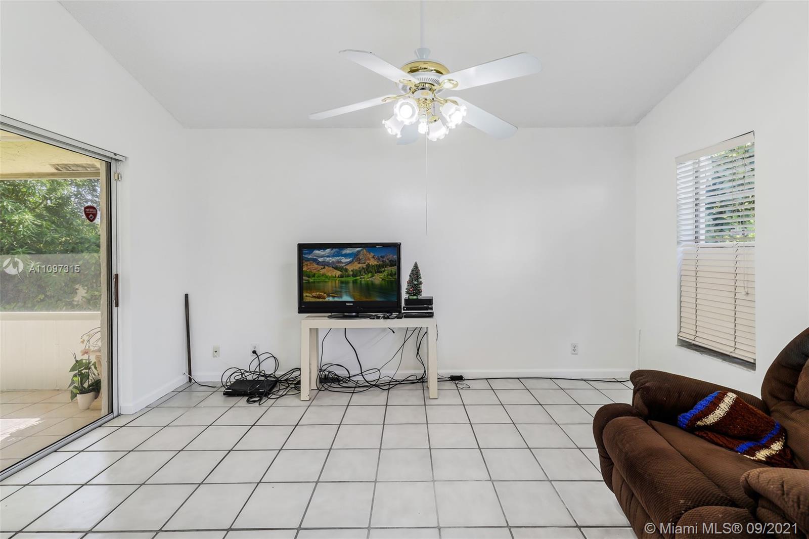 5140 Northwest 5th Avenue Boca Raton, FL 33487 - Photo 35 of 44 a living room with furniture and a flat screen tv