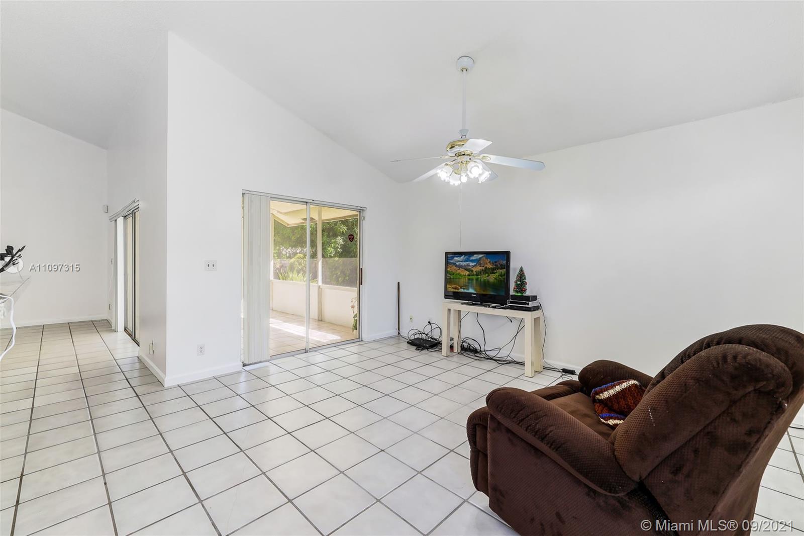 5140 Northwest 5th Avenue Boca Raton, FL 33487 - Photo 36 of 44 a living room with furniture and a flat screen tv