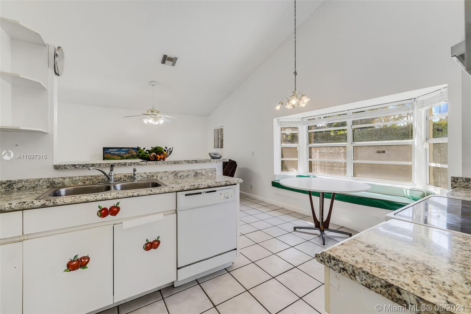 5140 Northwest 5th Avenue Boca Raton, FL 33487 - Photo 37 of 44 a kitchen with sink and cabinets