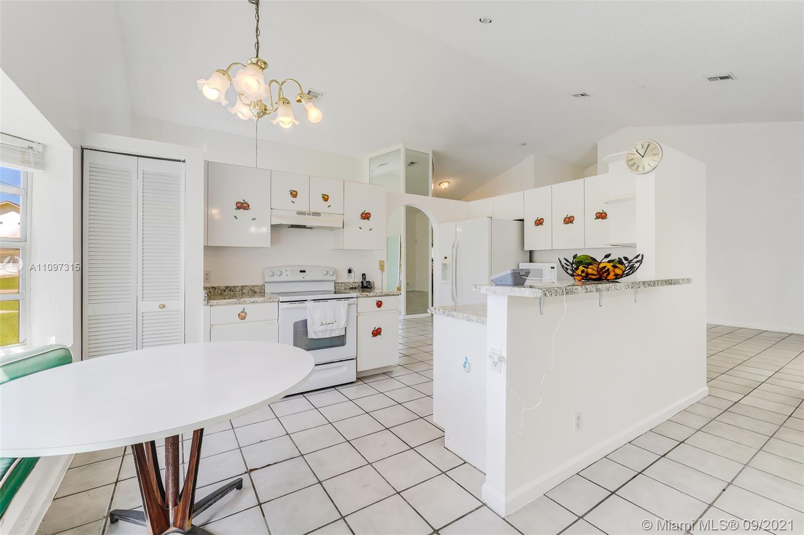 5140 Northwest 5th Avenue Boca Raton, FL 33487 - Photo 40 of 44 a kitchen with stainless steel appliances granite countertop a refrigerator and a stove