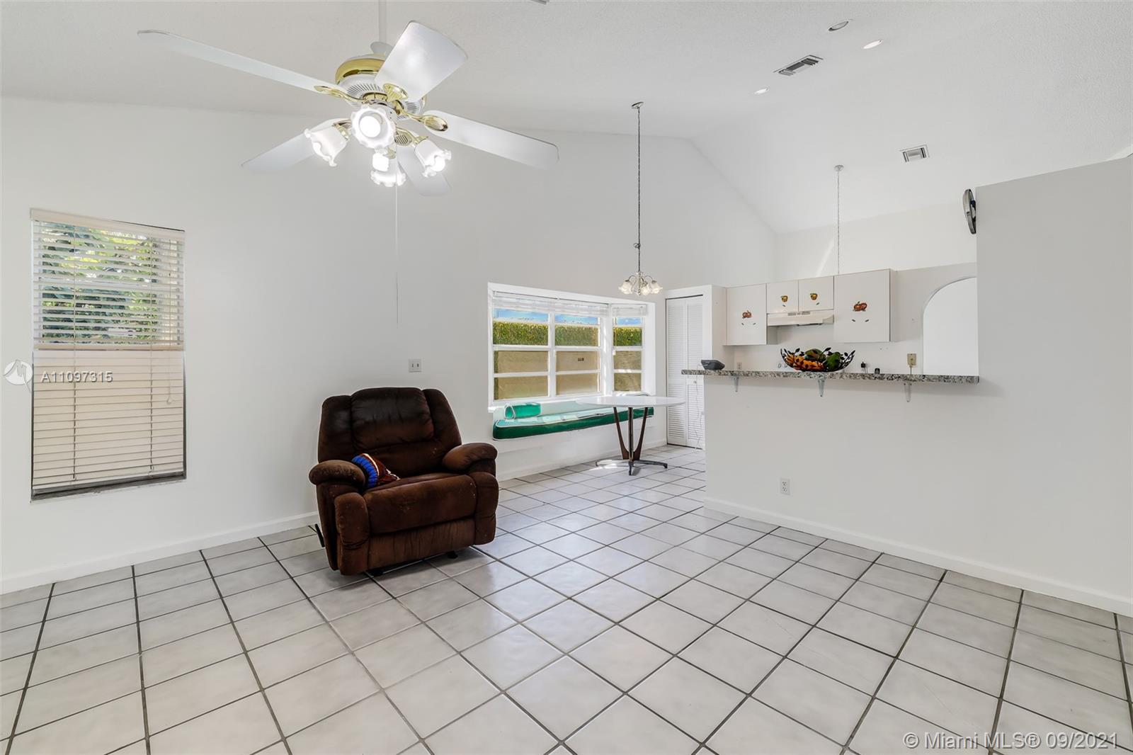 5140 Northwest 5th Avenue Boca Raton, FL 33487 - Photo 41 of 44 a living room with furniture and a chandelier