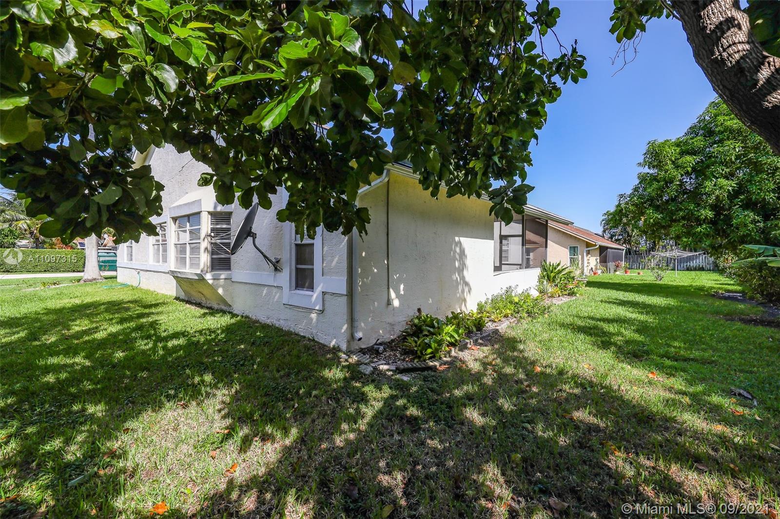 5140 Northwest 5th Avenue Boca Raton, FL 33487 - Photo 6 of 44 a view of a house with a big yard plants and large trees