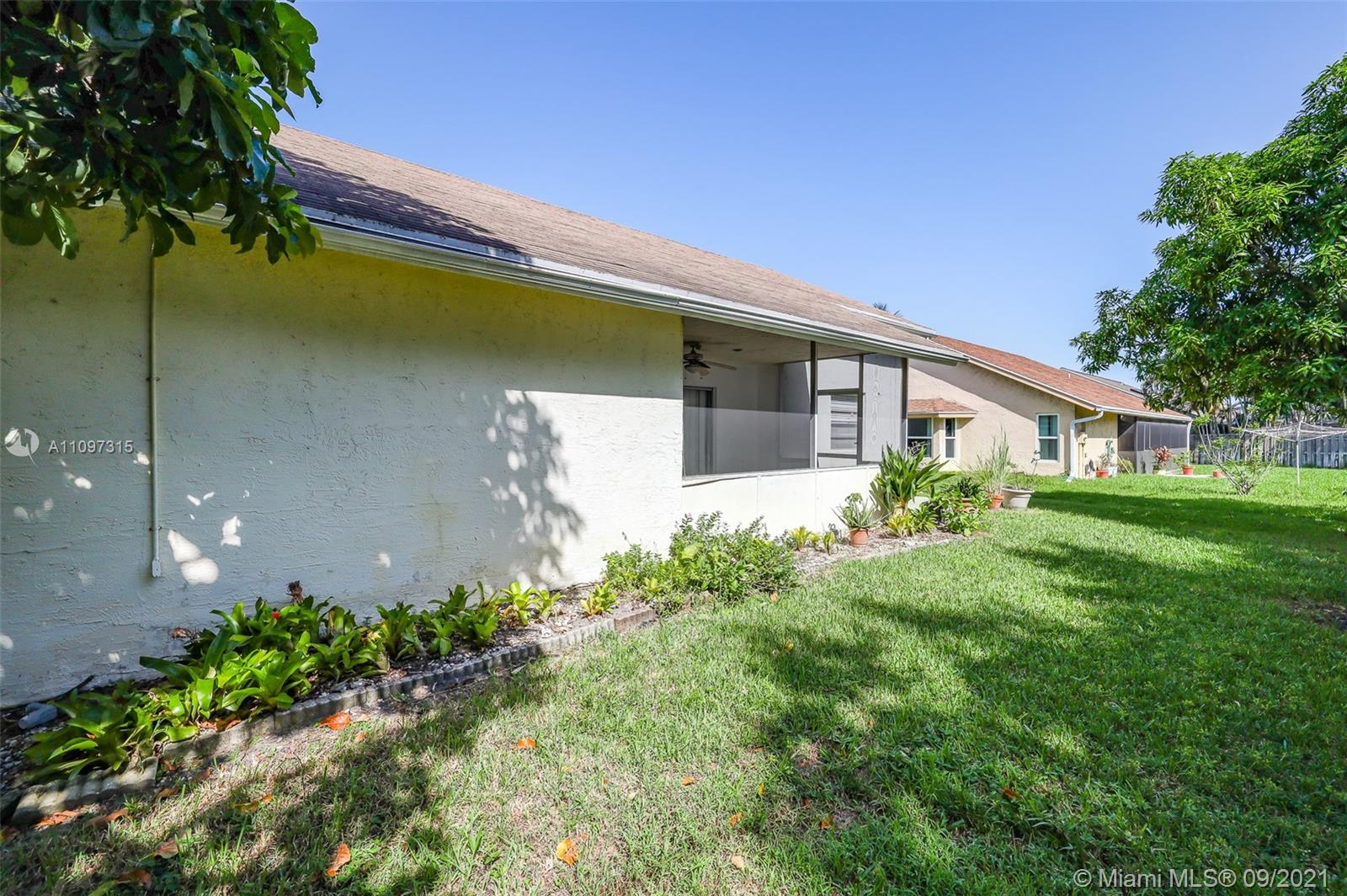5140 Northwest 5th Avenue Boca Raton, FL 33487 - Photo 7 of 44 a front view of a house with garden