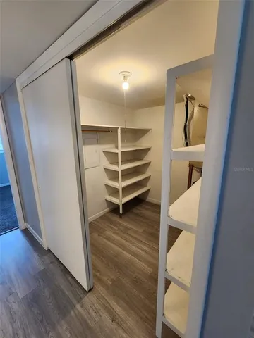 a view of walk in closet with empty racks