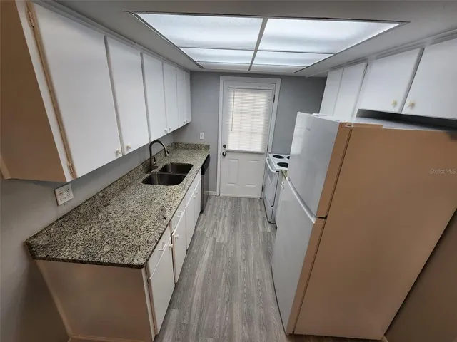 a kitchen with a refrigerator a sink and dishwasher