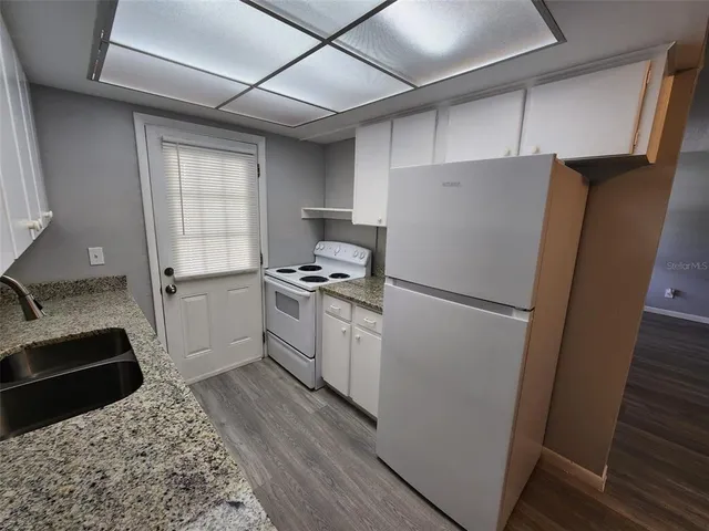 a white refrigerator freezer sitting inside of a kitchen