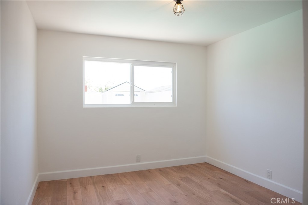 1466 East Helmick Street Carson, CA 90746 - Photo 18 of 32 an empty room with a window