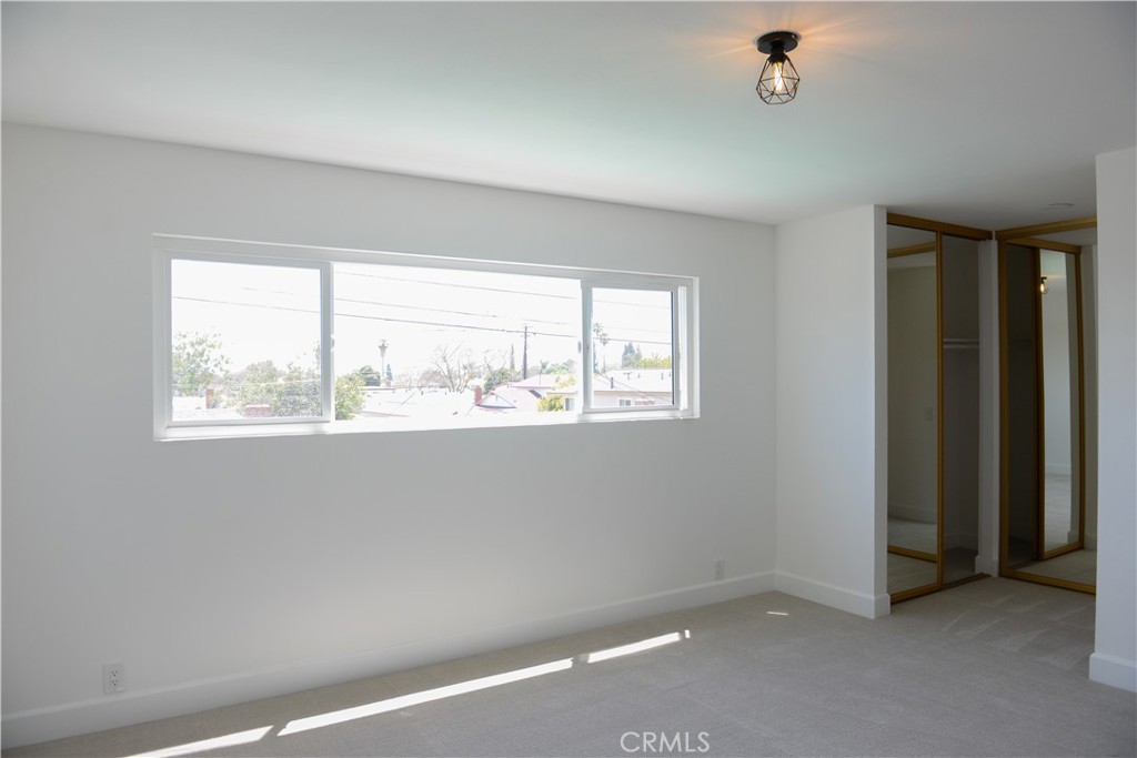 1466 East Helmick Street Carson, CA 90746 - Photo 25 of 32 an empty room with a window