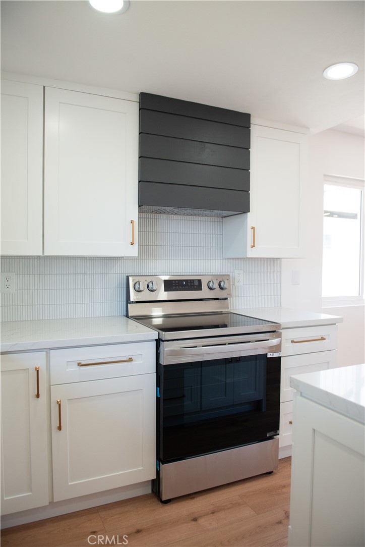 1466 East Helmick Street Carson, CA 90746 - Photo 7 of 32 a stove top oven sitting inside of a kitchen