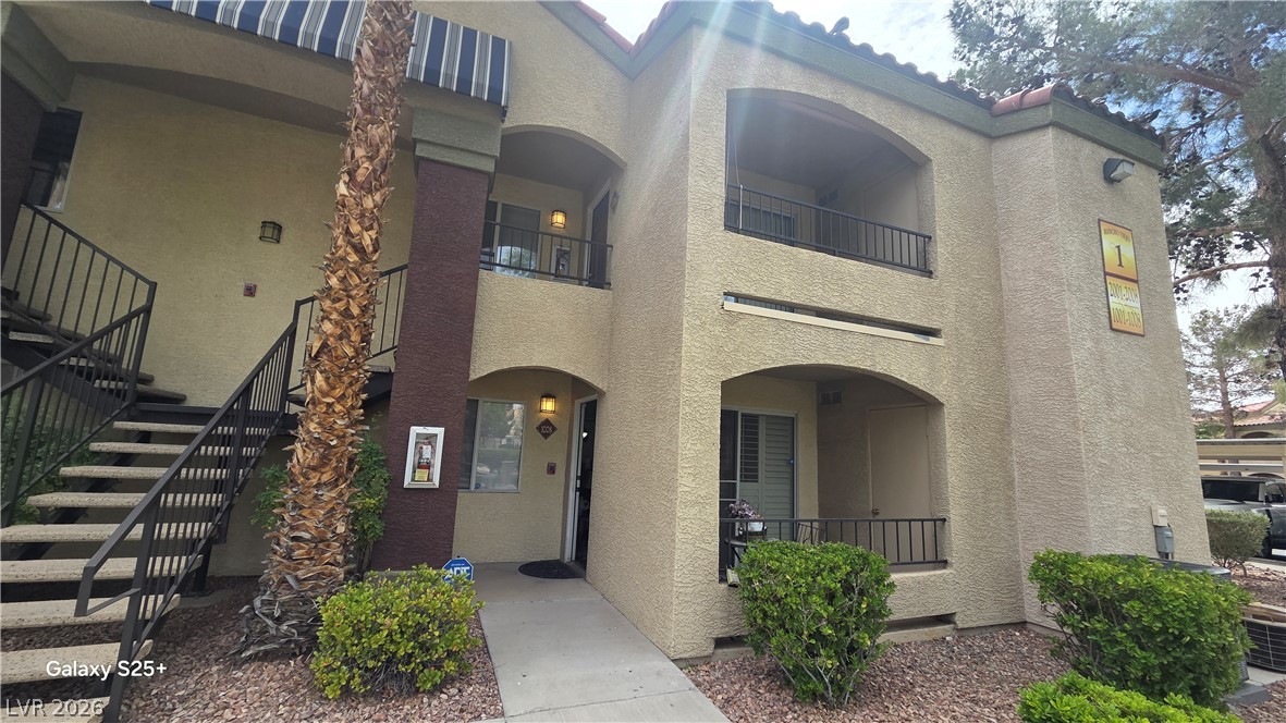 7885 West Flamingo Road, Unit 1008 Las Vegas, NV 89147 - Photo 24 of 29 A classic stucco facade with arched balconies and a tiled roof defines this charming multi-level residence.
