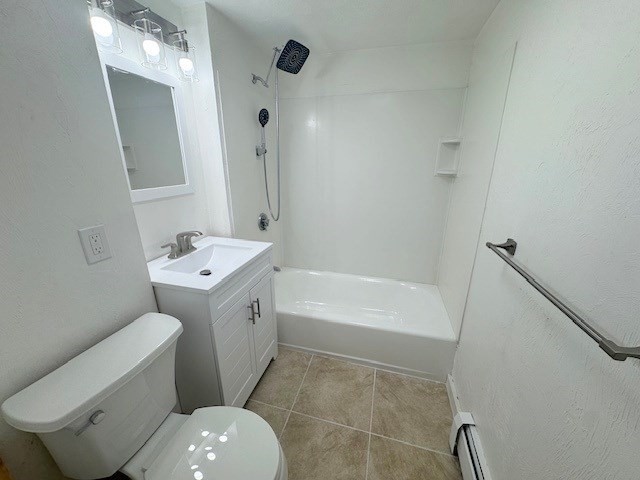 296 Broadway, Unit 2 Somerville, MA 02145 - Photo 11 of 13 a bathroom with a toilet sink and mirror