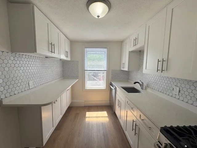 a kitchen with sink and cabinets
