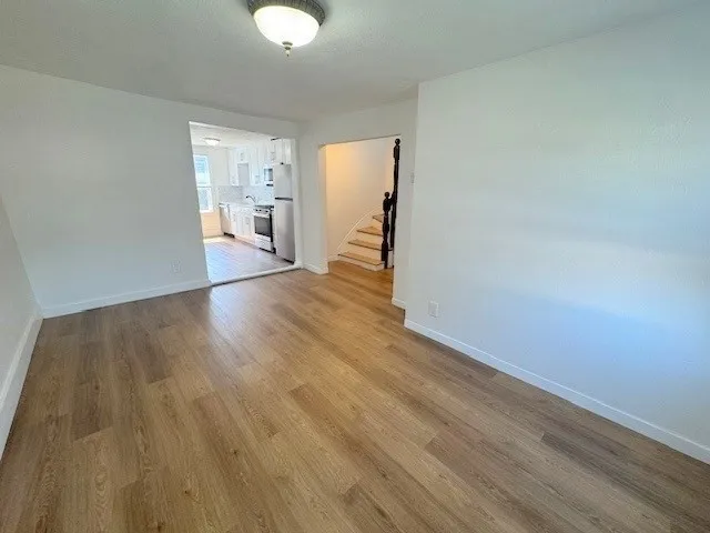 a view of a room with wooden floor and windows