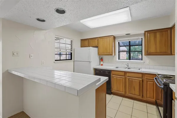 a kitchen that has a sink and a table in it