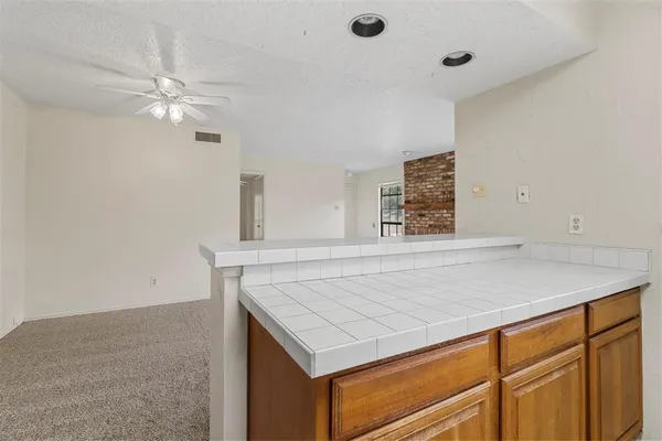 a room with a sink dishwasher and a refrigerator