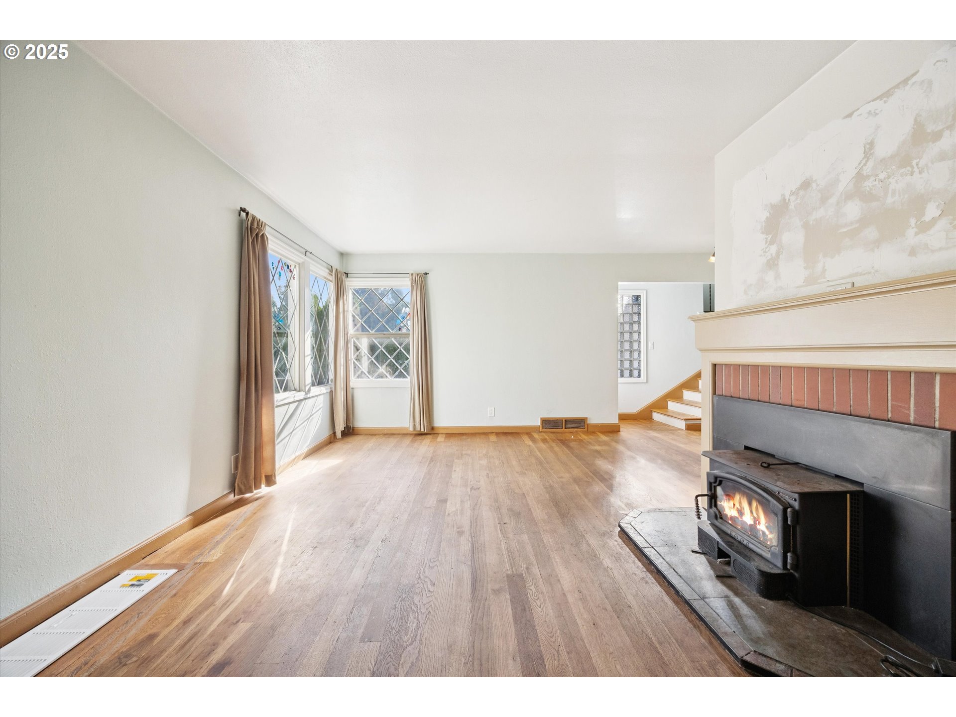 1115 Northeast 106th Avenue Portland, OR 97220 - Photo 12 of 46 a view of an empty room with wooden floor and a window