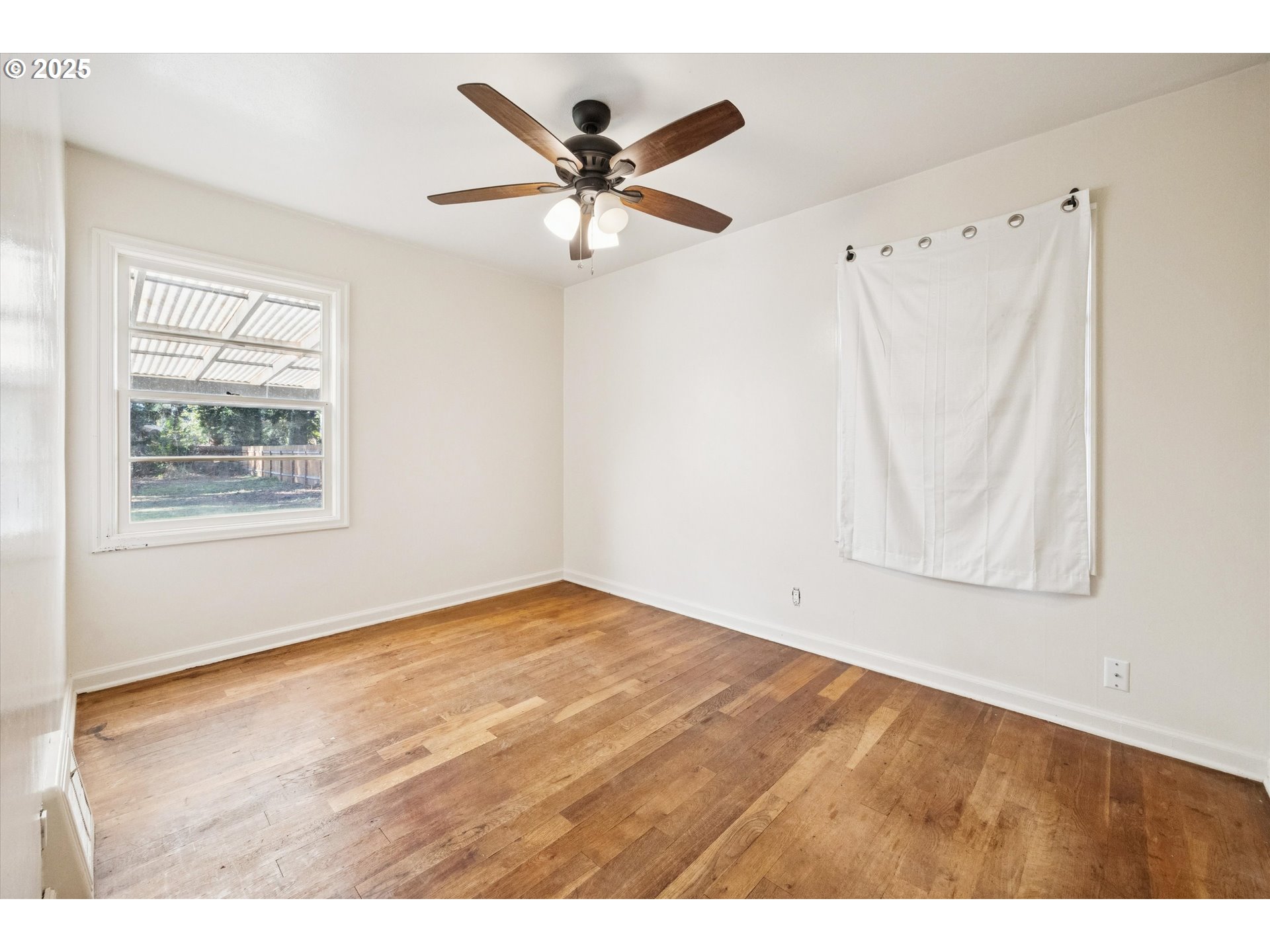 1115 Northeast 106th Avenue Portland, OR 97220 - Photo 20 of 46 a view of an empty room with window and wooden floor