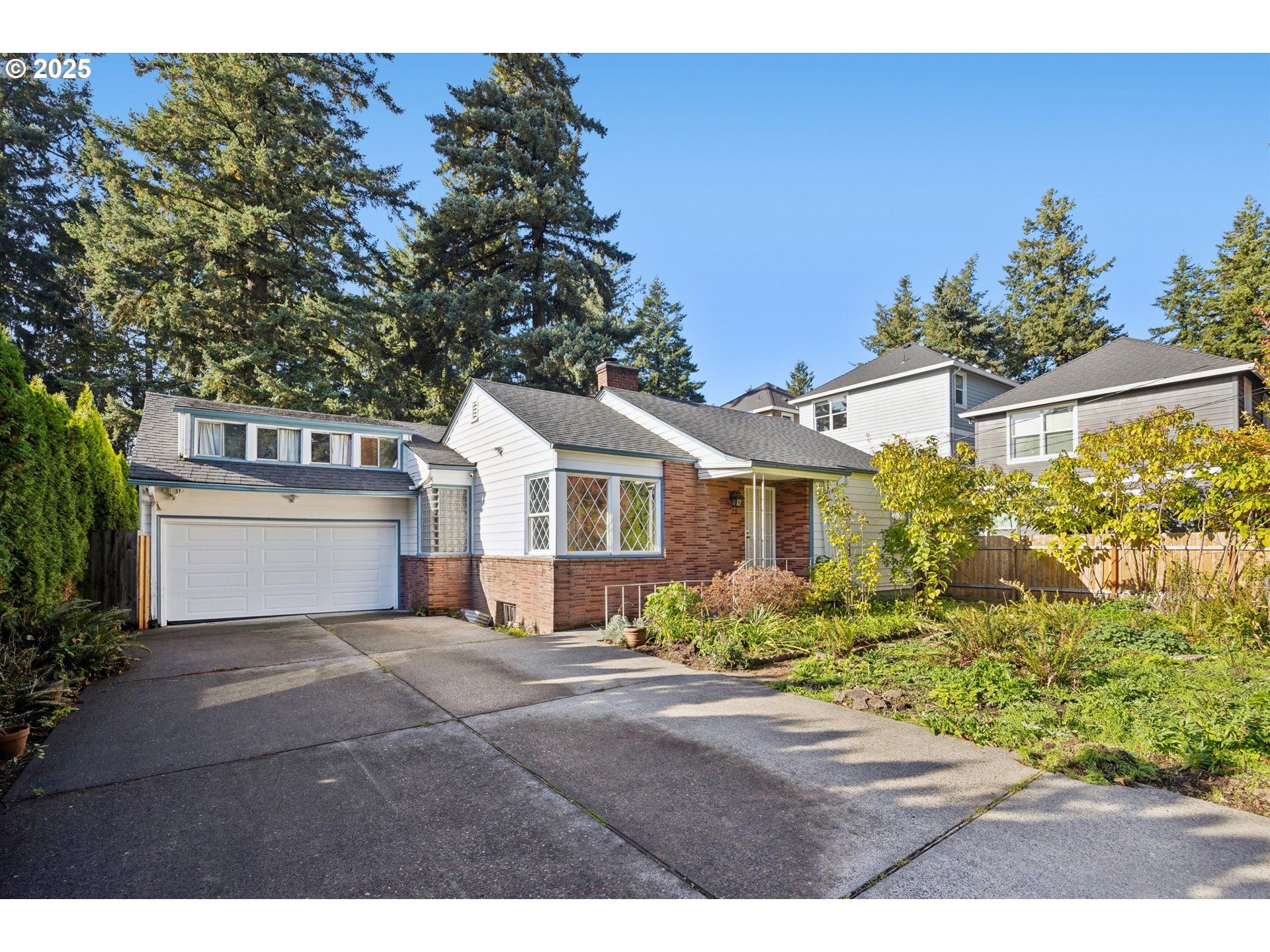 1115 Northeast 106th Avenue Portland, OR 97220 - Photo 4 of 46 a view of a white house with a big yard and large trees
