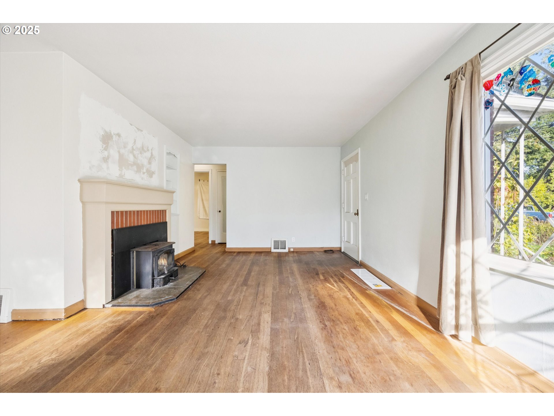 1115 Northeast 106th Avenue Portland, OR 97220 - Photo 8 of 46 a view of empty room with wooden floor and fireplace