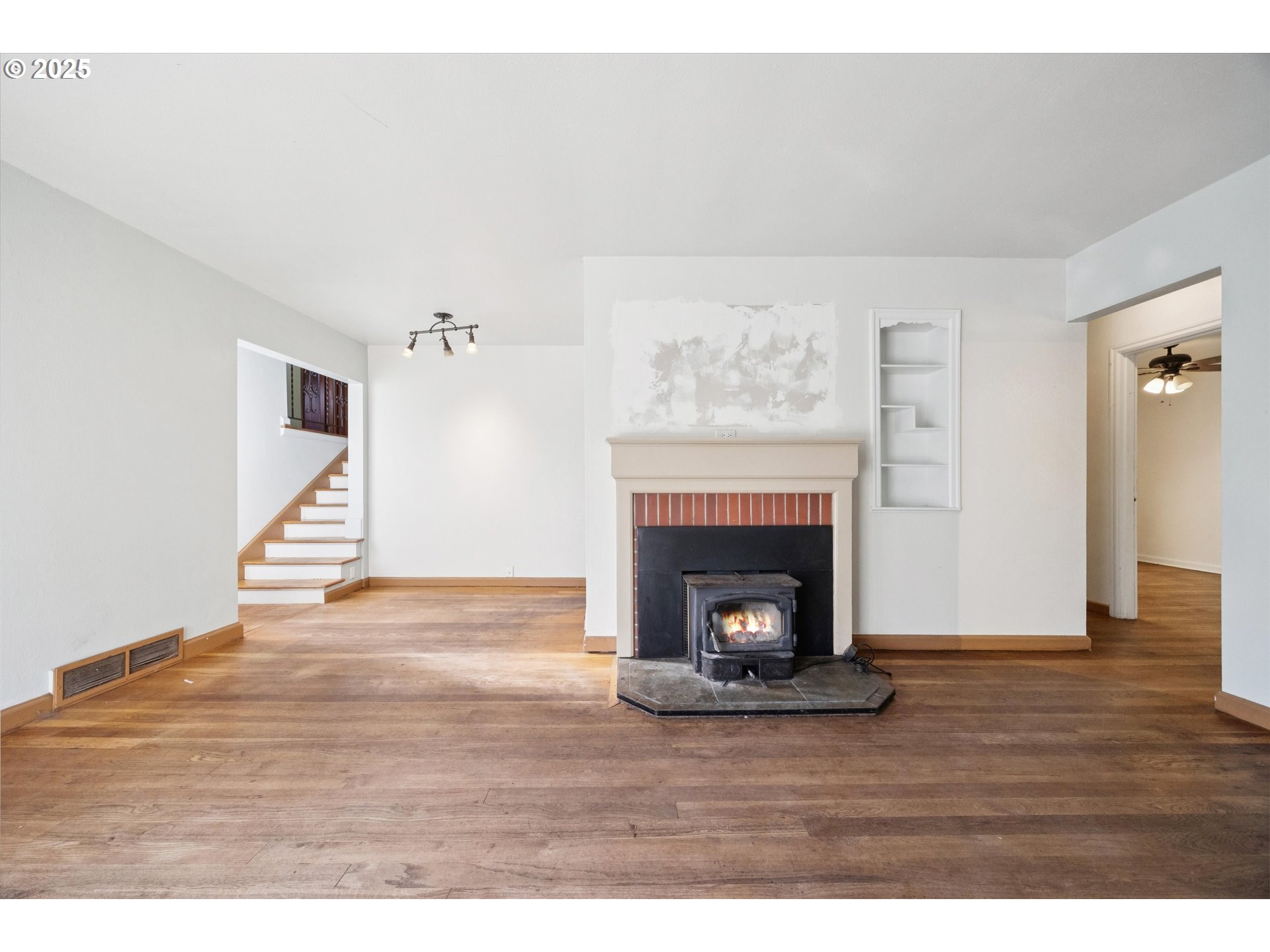 1115 Northeast 106th Avenue Portland, OR 97220 - Photo 10 of 46 a view of an empty room with wooden floor fireplace and a window