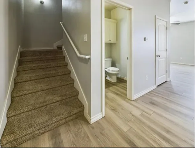 a view of hallway with wooden floor