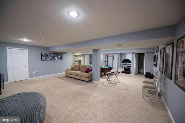 a spacious bedroom with a bed and a chandelier