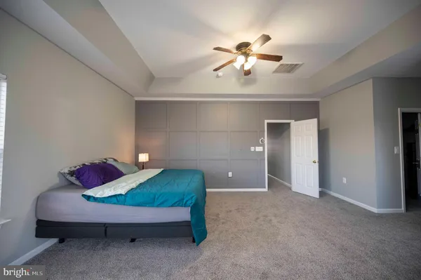 a bedroom with a bed and potted plant