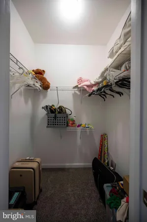a bedroom with a bed a bookshelf and a window