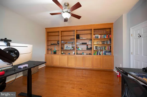 a view of a a dining room with furniture window and wooden floor