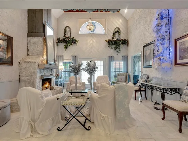 a living room with furniture a fireplace and a table