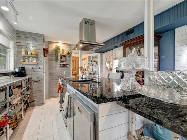 a kitchen with stainless steel appliances granite countertop a stove and cabinets