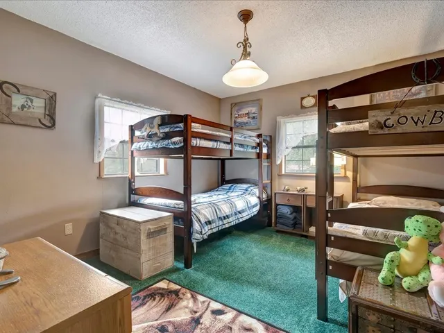 a bedroom with bed and a window