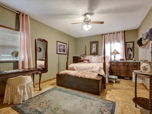 a bedroom with a bed lamps and dresser