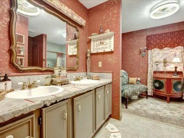 a en suite bathroom with a sink double vanity and a mirror
