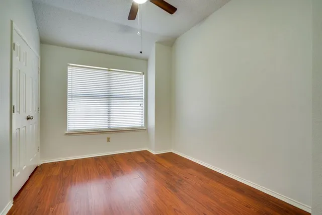 a view of a room with wooden floor