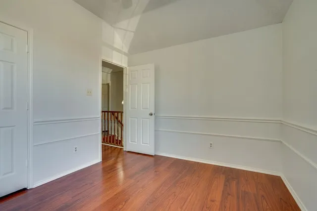 a view of a yard with wooden fence