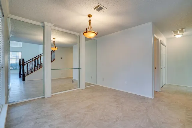 a view of a room with wooden floor and windows