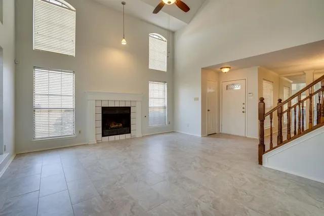 an empty room with windows and stairs