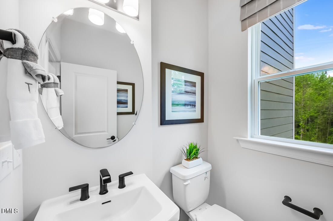 1324 West Garner Road, Unit 103 Garner, NC 27529 - Photo 15 of 27 a bathroom with a sink mirror and toilet